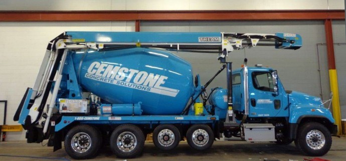 A blue truck with a cement mixer attached to it.