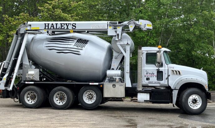 A large truck with a concrete mixer on it.