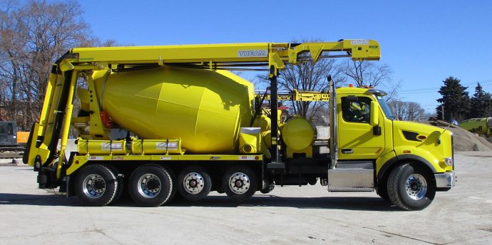 A yellow truck with a cement mixer on it.