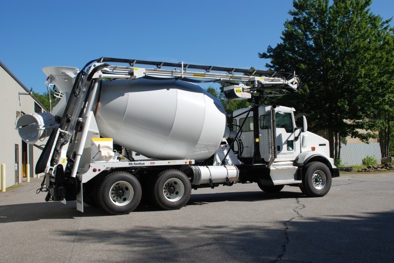 A concrete mixer truck parked in a parking lot.