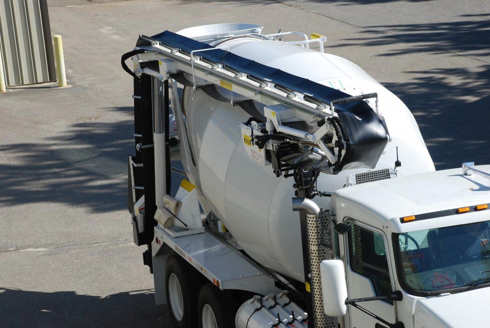 A white truck with a mixer attached to it.