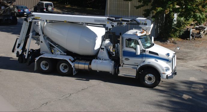 A concrete mixer truck is parked in a parking lot.
