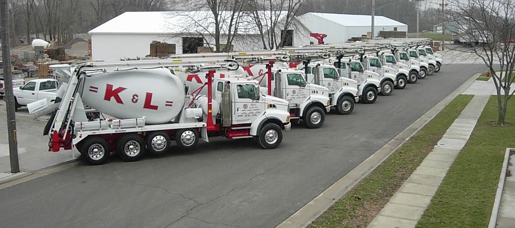 A group of trucks parked on the side of the road.
