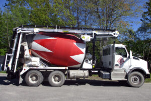 A truck with a cement mixer.